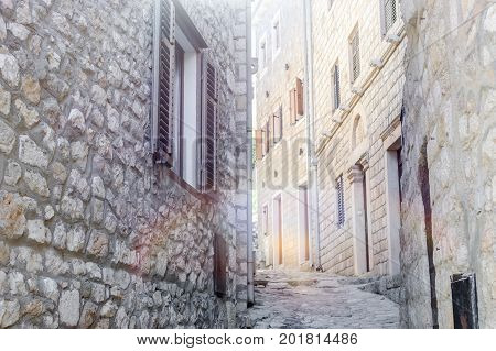 Old narrow street in Stari Grad of Ulcinj Montenegro. The fortress in the Old town in a sunny summer day.