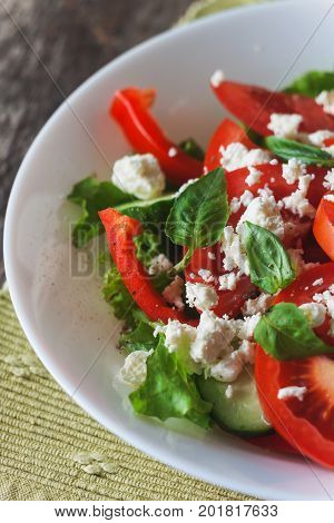 Shopska Salad In A White Plate On A Wooden Background, Close-up