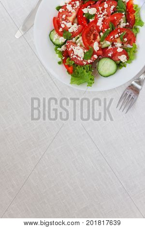 Shopska Salad In A White Plate On A White Tablecloth. The Concept Of Minimalism