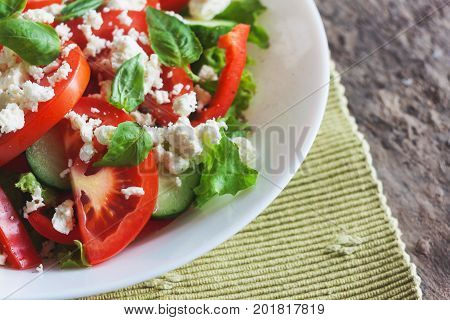 Shopska Salad In A White Plate On A Wooden Background, Close-up