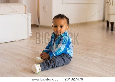 Portrait of a little african american baby boy playing indoor.
