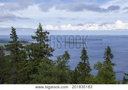 View of lake Pielinen, from Ukko-Koli hill in Karelia, Finland. Trees this side, sunshine.