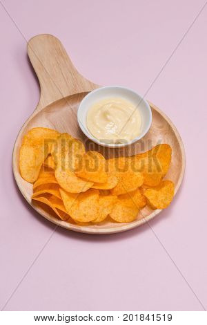Concept of unhealthy food. Potato chips in a bowl and ketchup