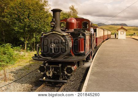 Tanygrisiau Wales UK - August 22 2017: Narrow gauge Double Fairlie steam locomotive Merddin Emrys of the Ffestiniog Railway Company part of the heritage line that runs through the Snowdonia National Park