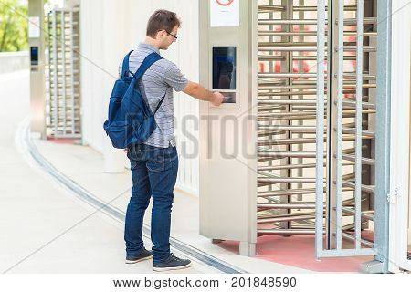 Young Man Puts The Card Into The Reader System
