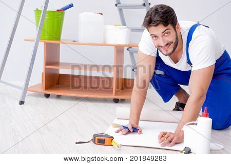 Repairman doing renovation repair in the house with paper wallpa