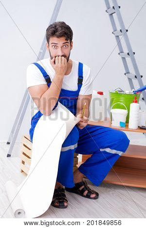 Repairman doing renovation repair in the house with paper wallpa
