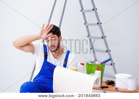 Repairman doing renovation repair in the house with paper wallpa