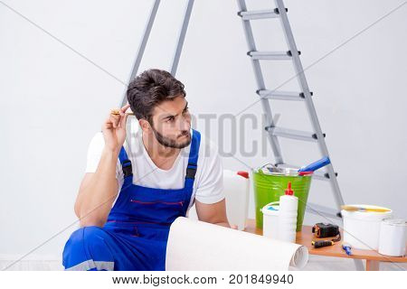 Repairman doing renovation repair in the house with paper wallpa