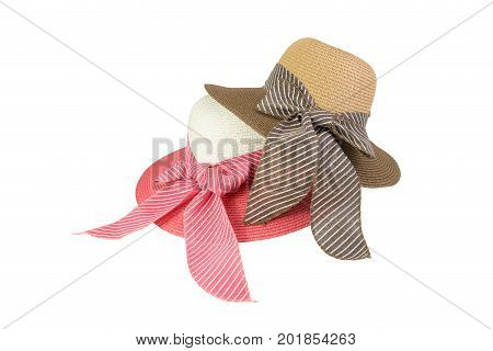 Woven hat with pink, beige and brown, decorated with a pink bow tie, isolated on white background.