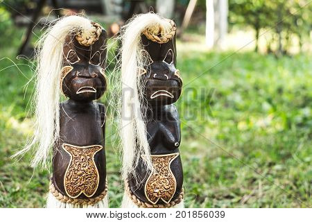 a wooden figures of people from tribes