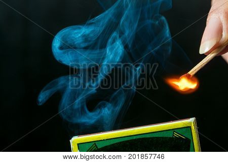 Woman striking a match and make a fire