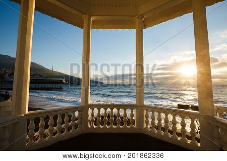 Storm at the sea and embankment street of Yalta city in Crimea in the morning on 24.10.2016. Big waves and tides wash against with lots of splashes.