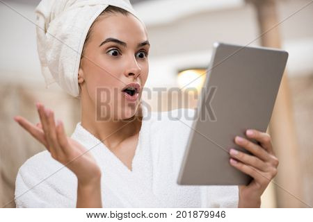 Shocked Woman Using Digital Tablet