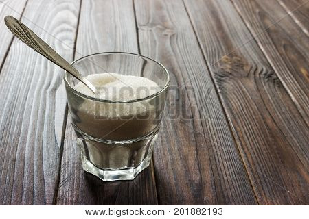 Sugar bowl with spoon in kitchen macro close up