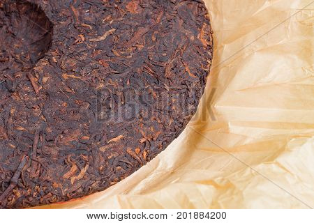 Round Flat Disc of Traditional Chinese Shu Puer or Puerh Tea in cover paper