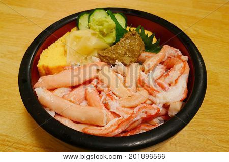 Kanidon japanese crab bowl with kanimiso and sweet egg in red black bowl on wooden background delicious japan seafood cuisine.