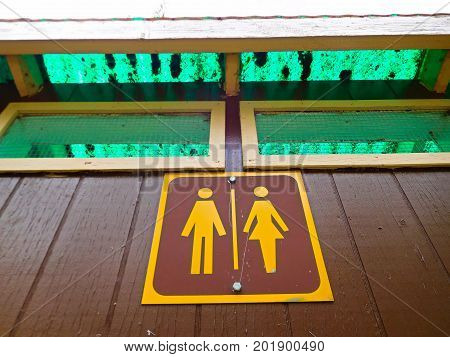 A Female and Male Sign for a Public Outdoor Toliet.