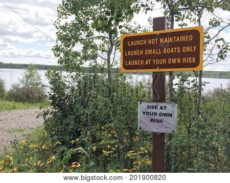 Small Unmaintained Boat Launch With Warning Signs