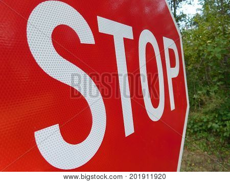 A macro view of a stop sign from the side