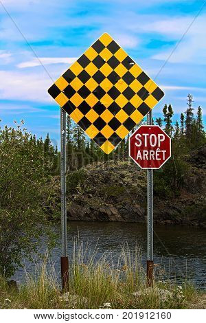 A Checkered No Entry And Stop Sign In Both English And French