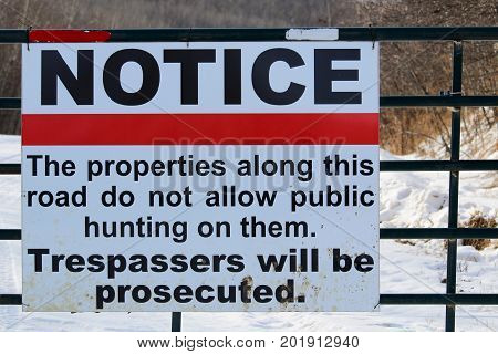 No Trespassing Or Hunting Sign On A Gate