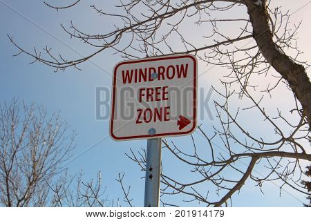 Windrow Free Zone Sign Against Blue Sky