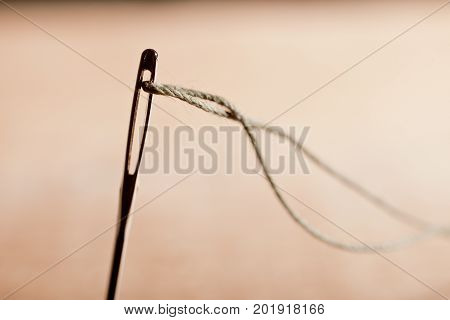 Detail of a Needle with Thread in the Workroom.