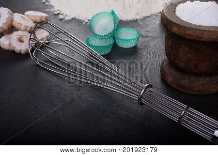 Blender whip and canestrelli Italian shortbread cookies on black table