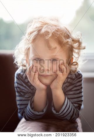 Young Boy With Blonde Curly Hair Posing