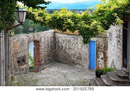 old stone castle courtyard with blue door in Breisach Germany