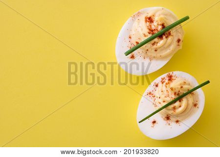 Classic stuffed egg on yellow background ( deviled egg)