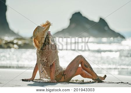 young woman relaxing on the beach in summer day