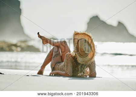 young woman relaxing on the beach in summer day