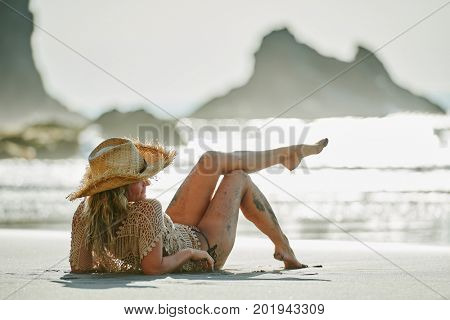 young woman relaxing on the beach in summer day