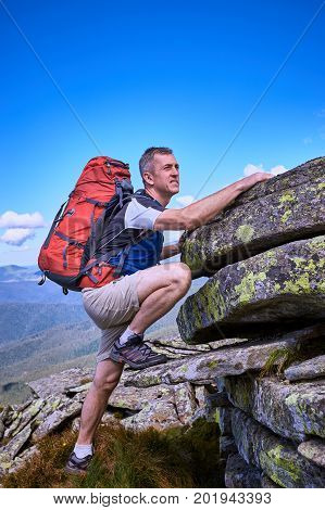 Hiking in the mountains with a backpack in the summer.