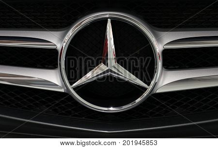 CRACOW POLAND - MAY 20 2017: Mercedes metallic logo closeup on Mercedes car displayed at 3rd edition of MOTO SHOW in Cracow Poland. Exhibitors present most interesting aspects of the automotive industry