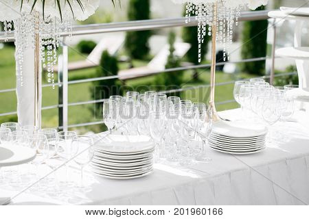 Detail of a table dish with glasses at an event on a sunny summer day. party in a Villa on the shore of the sea