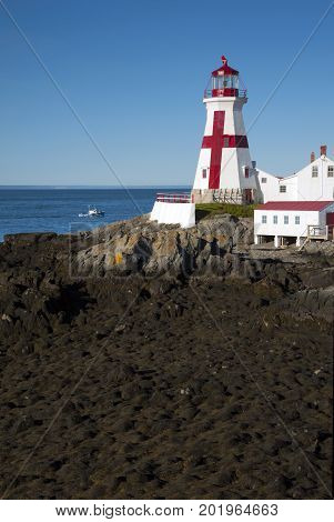 Head Harbor light, also referred to as East Quoddy Head lighthouse, guides mariners around Campobello Island during low tide along the Canadian eastern coast.