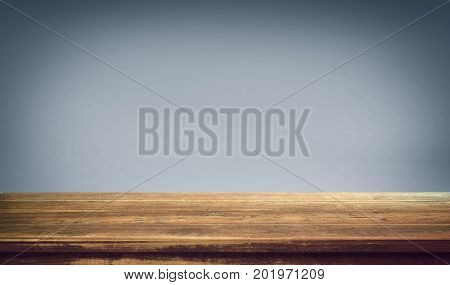 Wood table top on gradient background .