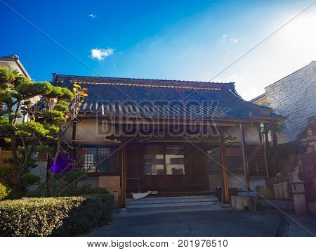 OSAKA, JAPAN - JULY 02, 2017: Beautiful ancent house with a small garden with plants in a sunny blue sky near of Osaka, Japan.