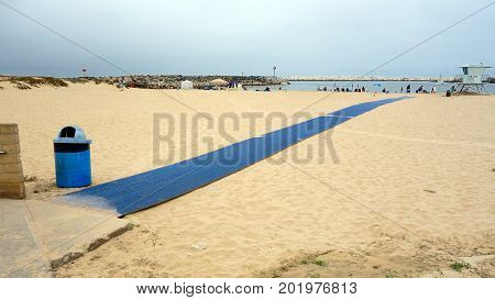 VENTURA CA USA - JULY 4 2013: Blue welcome carpet strip for beachgoers to enjoying holiday at Ventura city beach near Harbor Village Southern California