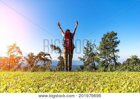 Hiker woman feeling victorious facing on the mountainHiker woman feeling victorious facing in the forest Thailand