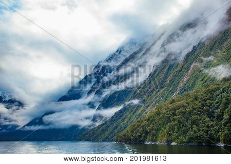 white cloud and high mountain in milford sound fiord land national park new zealand most popular traveling destinaton