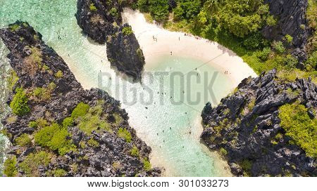 El Nido Palawan National Park Philippines. Warm Hidden Lagoon Near The Rocks. Tourists Relax On The 