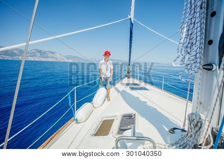 Little Boy On Board Of Sailing Yacht On Summer Cruise. Travel Adventure, Yachting With Child On Fami