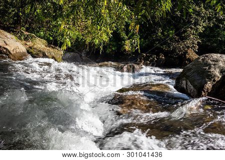 Waterfall Water Flow In Rocks With Green Forests. This Image Is Taken At Marmala Waterfall Vagamon K
