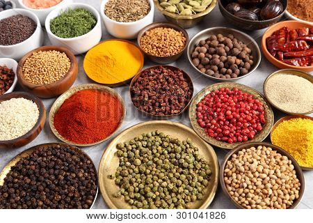 Aromatic Spices And Herbs In Metal And Ceramic Bowls.