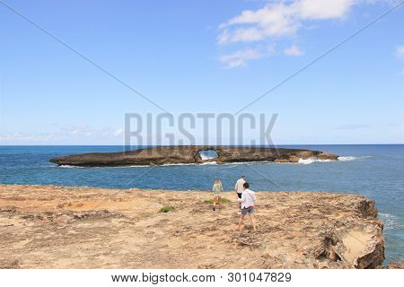 Leie, Hawaii - 4/30/2018 - Tourists Exploring The Rocky Coast Line Of Leie Point, A Popular Tourist 