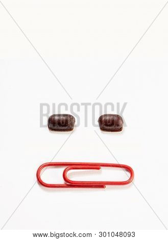 Cockroach Eggs Size Relative Comparison Between Paper Clip. Two Cockroach Egg Capsule And Red Paper 